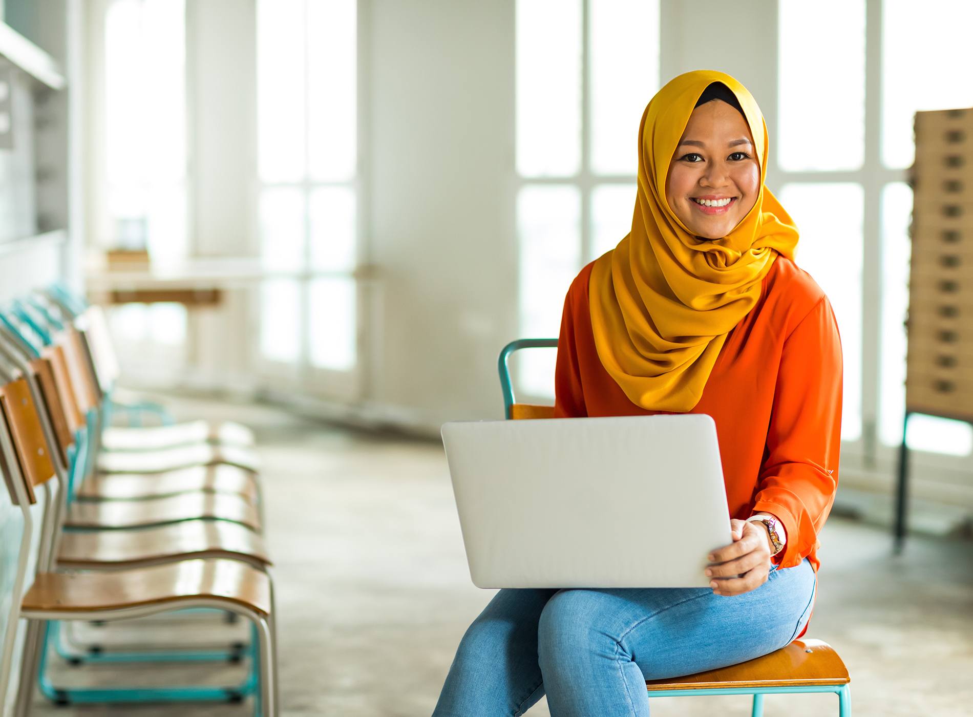 Woman sitting in chair with laptop